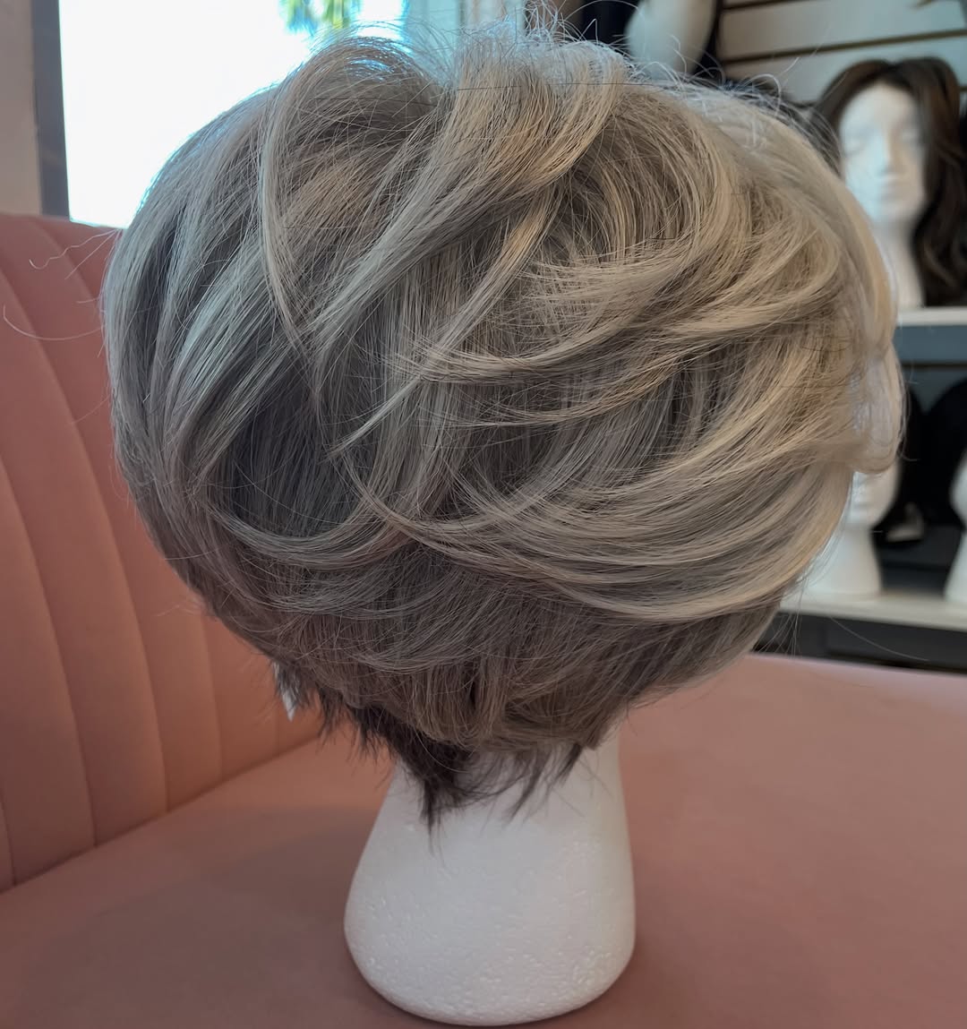 Instagram post by Dr. Adam S. Greenberg: Can you believe this is synthetic? 😍 Are you looking for grey hair options? We would love to see you! Make an appointment today! 941-600-63…