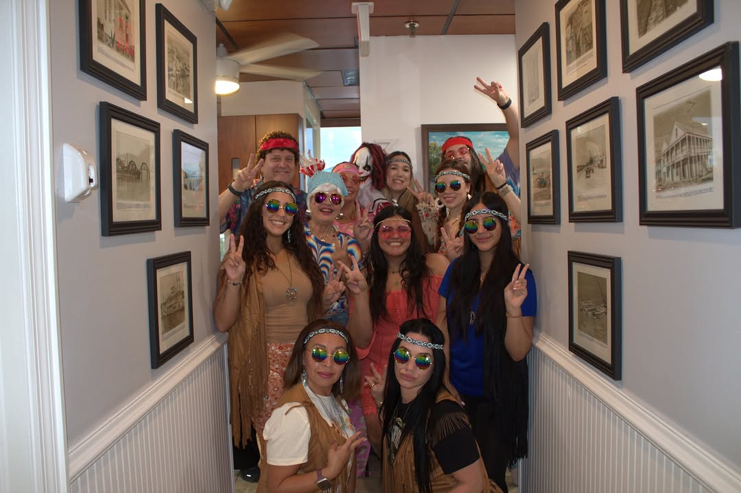 Instagram post by Dr. Alvaro Maya, D: ✨Peace, love, and perfect smiles! ✌️💛🦷 This Halloween, the Overseas Dental crew traveled back to the groovy ‘60s — spreading good vibes an…