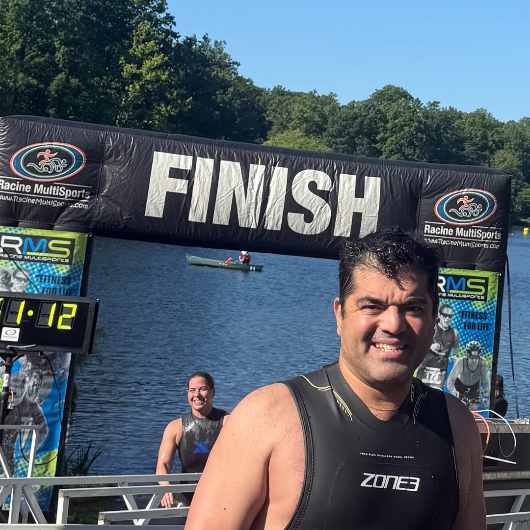 Instagram post by Dr. Amir Bajoghli: Beautiful morning for a lake swim race this past weekend. 🏊♂️ Grateful to have raced and also served alongside Dr. Hong, helping staff the…