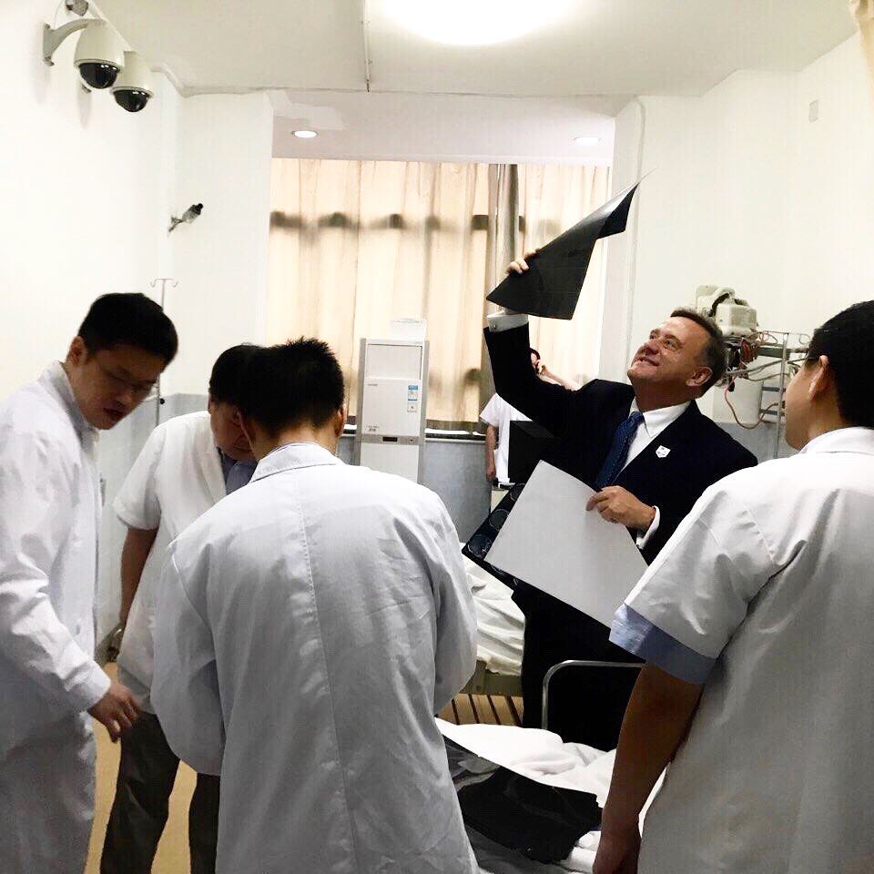 Instagram post by Dr. Chester F. Griffiths: Reviewing imaging prior to a procedure at Fudan University's Department of Neurology in Shanghai.