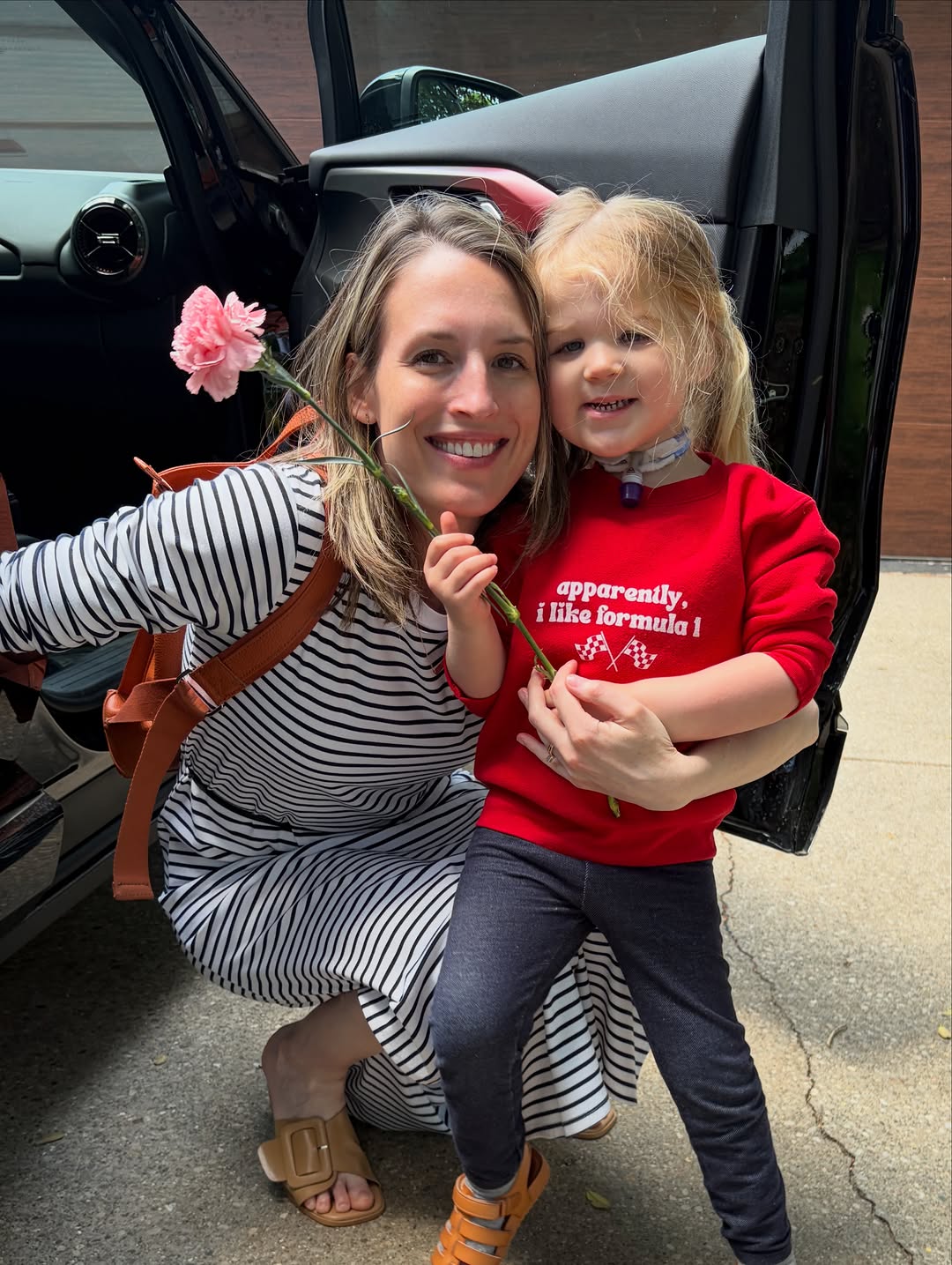 Instagram post by Dr. F. Ryan Wermeling: Thanks to the random cyclist handing out flowers to moms on Logan Street today! This mom is best.