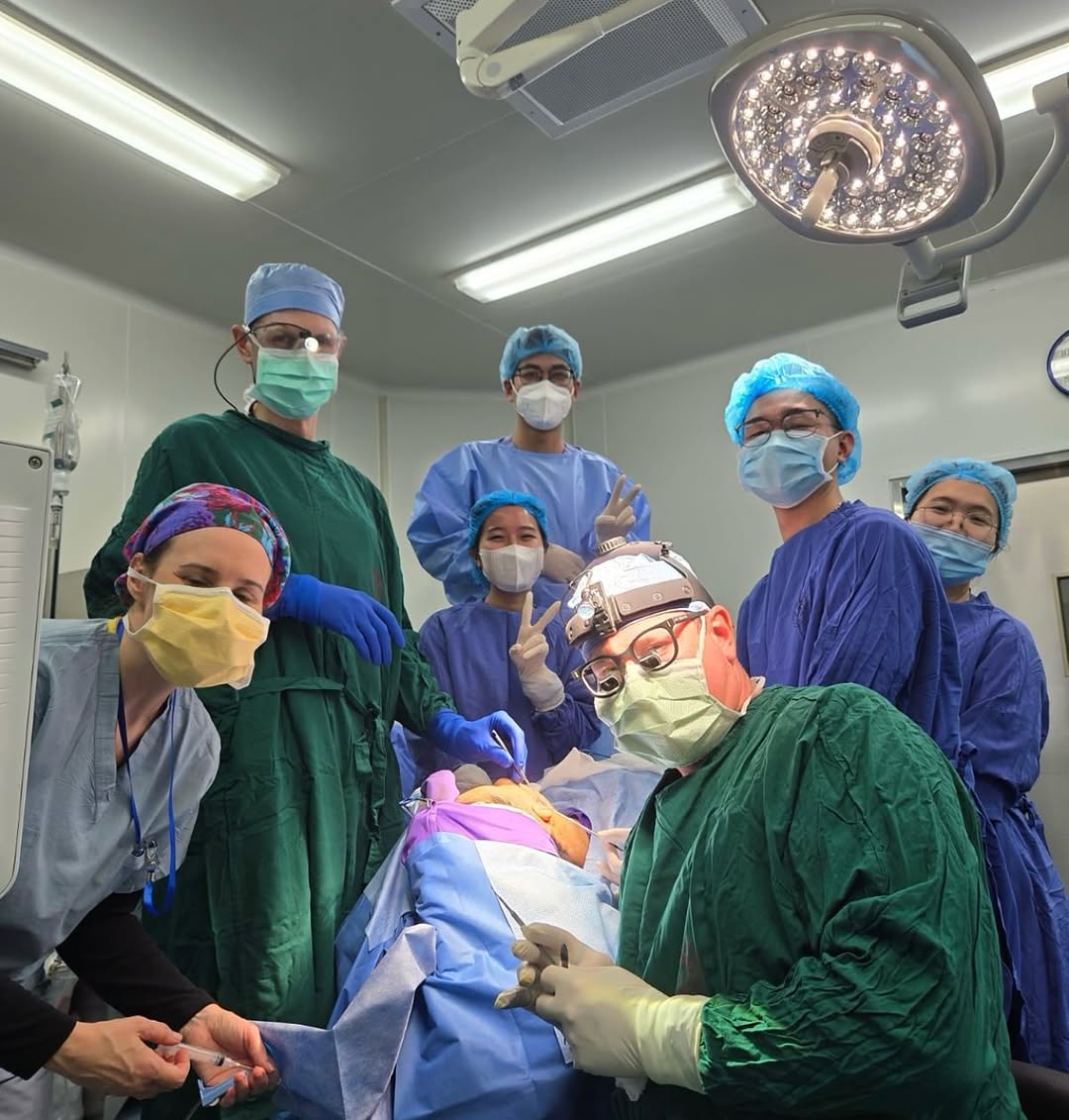 Instagram post by Dr. James M. Pearson: . Intra-op group photo with @dr.scottthompson and @hugginslily and 4 local surgeons. One of the best aspects about our Vietnam surgical miss…