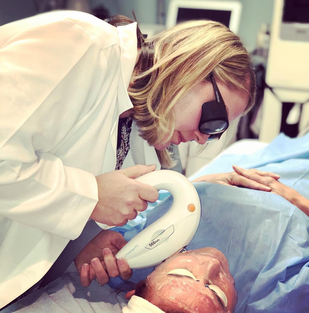 Instagram post by Dr. Kathleen W. Judge: Chelsea is doing an Intense Pulsed Light (IPL) treatment on Dr. Judge, “because all the cool kids are doing it”. Joking aside, it is an amaz…