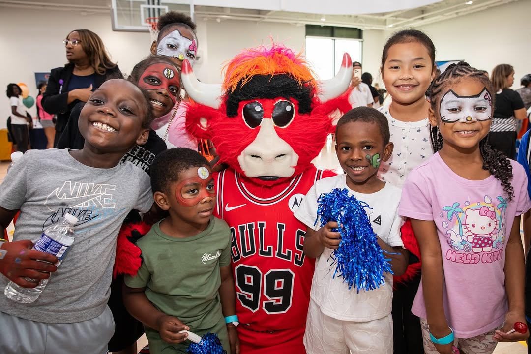 Instagram post by Dr. Loren Schechter: It was all smiles at the Back-to-School Community Summer Fest. Rush invited our friend @bennythebull to the Sankofa Village Wellness Center …
