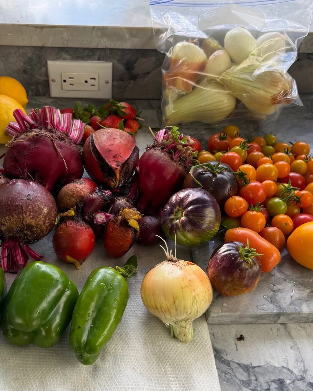 Instagram post by Dr. Marc M. Kerner: Daily harvest-detroit red beets, golden beets, cherry and heirloom tomatoes, onions, bell peppers and lemons. #organic #gardening