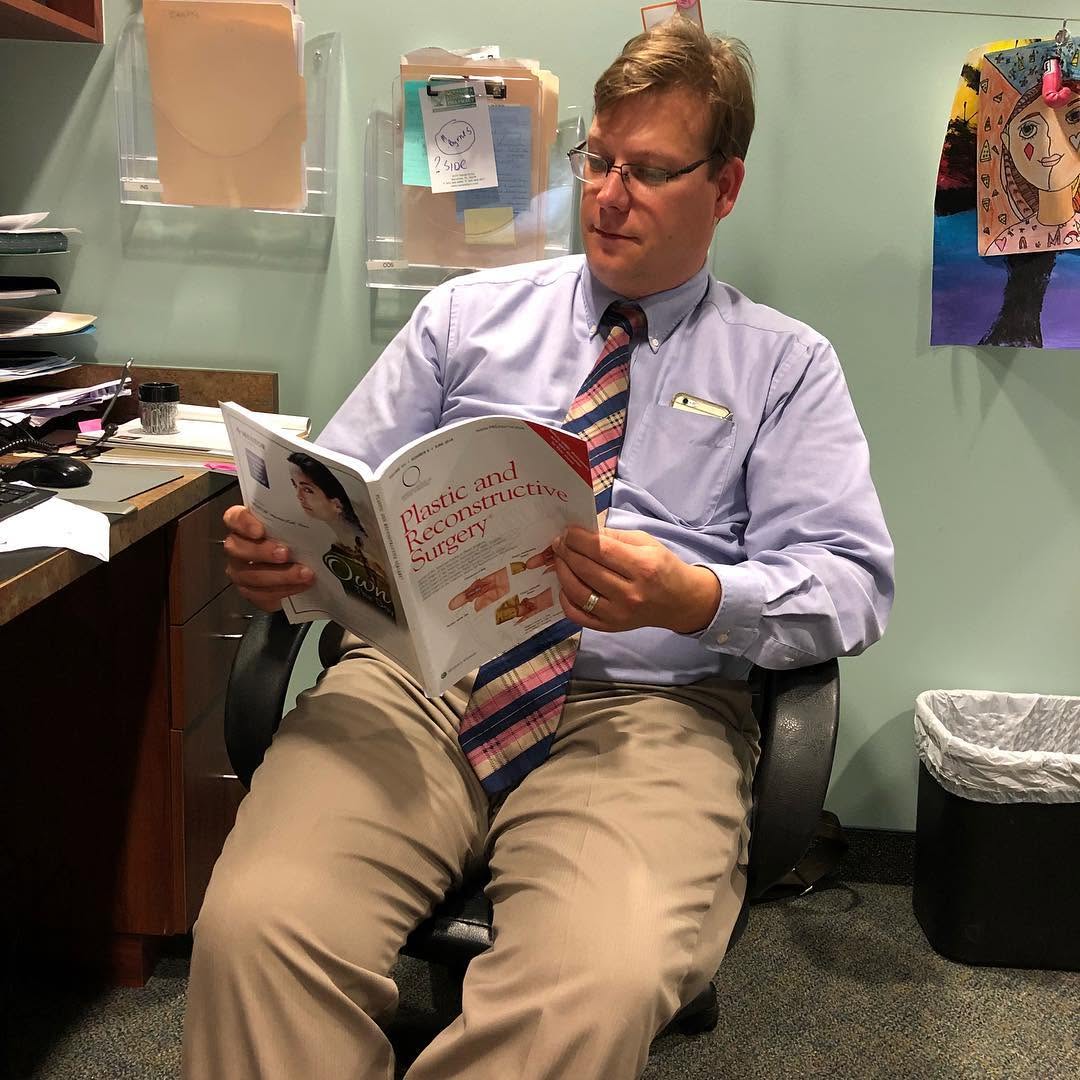 Instagram post by Dr. Mark E. Mathieson: Dr.Mathieson reading his favorite magazine #sarasotaplasticsurgeon #sarasotaplasticsurgery #drmarkmathieson#sarasotacosmeticsurgery