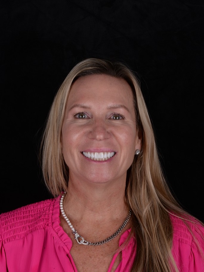 Close-up of a woman smiling, showing even, natural-looking veneers with a bright and balanced appearance.