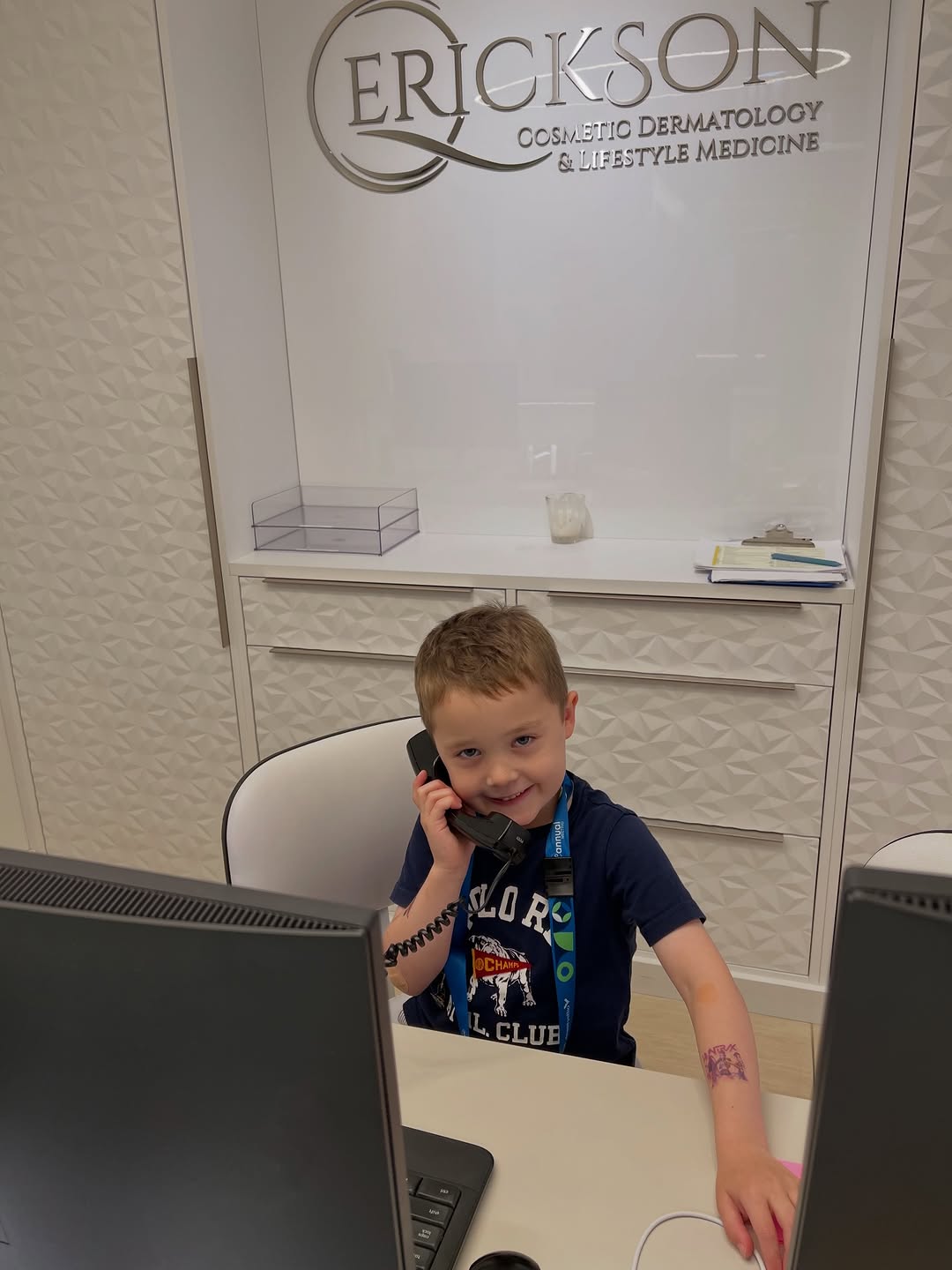 Instagram post by Dr. Quenby Erickson, DO, FAAD, FACMS: Summer help is here! ☀️🥼Our cutest assistant is on the job to brighten everyone’s day 💙